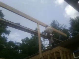 Carpenter setting a ridge beam over a new addition frame — Ice Dam Removal by Roofing Brothers in Brigham City
